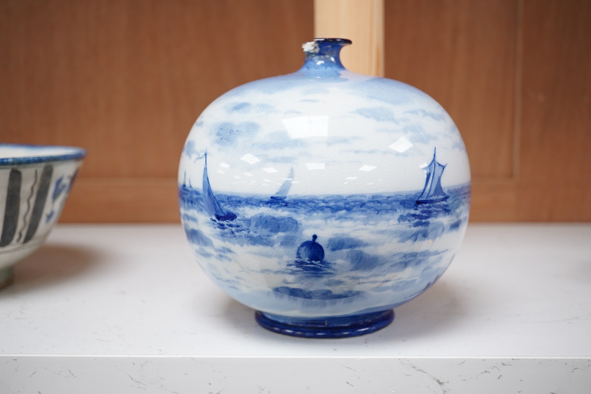 A Doulton Burslem Mount Edgecumbe, Plymouth blue and white signed vase, 14.5cm high. Condition - top rim broken